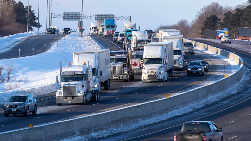 Trucks from the 'Freedom' convoy travel on Highway 401 headed eastbound in Kingston, Ont., headed for Ottawa, on Friday Jan. 28, 2022. THE CANADIAN PRESS/Lars Hagberg 