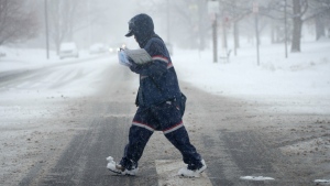 A U.S. Postal Service carrier during a winter storm in Denver, on Jan. 25, 2022. (David Zalubowski / AP) 