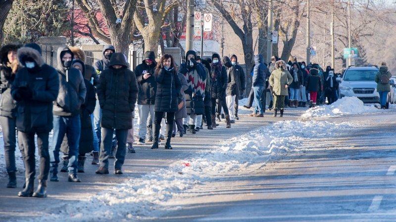 People wait in line to receive a COVID-19 test in Montreal, Tuesday, December 21, 2021, as the COVID-19 pandemic continues in Canada and around the world. THE CANADIAN PRESS/Graham Hughes 