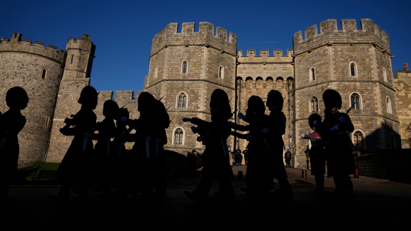 Members of the British Military's 1st Battalion Grenadier Guards take part in the changing of the guard ceremony outside Windsor Castle in Windsor, England, where Prince Andrew's residence is nearby in the grounds of Windsor Great Park, Thursday, Jan. 13, 2022. (AP Photo/Matt Dunham) 