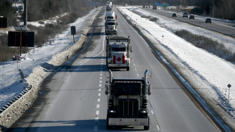 Trucks participating in a cross-country convoy protesting a federal vaccine mandate for truckers, make their way along Highway 416 into Ottawa, Jan. 28, 2022. THE CANADIAN PRESS/Justin Tang