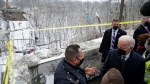 U.S. President Joe Biden talks first responders as he visits the site where the Fern Hollow Bridge bridge collapsed Friday, Jan. 28, 2022, in Pittsburgh's East End. (AP Photo/An
