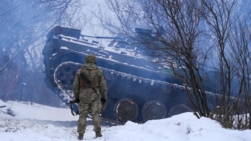 An Ukrainian serviceman as an armored personnel carrier maneuvers near front line position in the Luhansk area, eastern Ukraine, Friday, Jan. 28, 2022. (AP Photo/Vadim Ghirda) 
