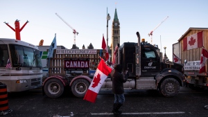 Trucks participating in a cross-country convoy protesting measures taken by authorities to curb the spread of COVID-19 are parked on Wellington Street in front of Parliament Hill in Ottawa, on Friday, Jan. 28, 2022. THE CANADIAN PRESS/Justin Tang