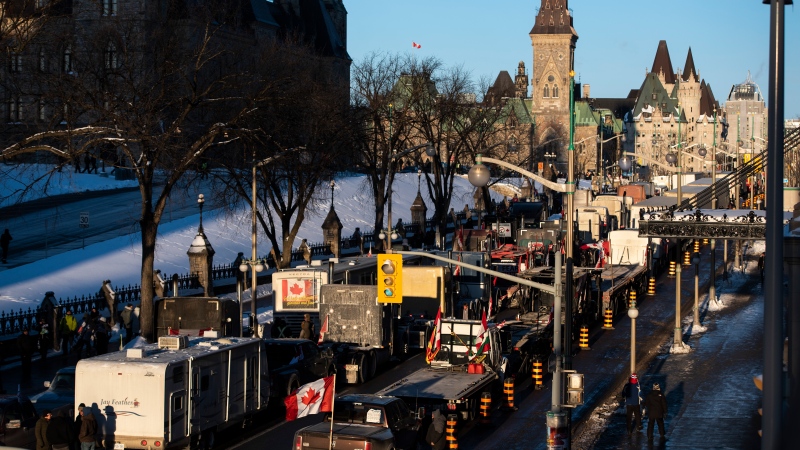 Trucks participating in a cross-country convoy protesting measures taken by authorities to curb the spread of COVID-19 are parked on Wellington Street in front of Parliament Hill in Ottawa, on Friday, Jan. 28, 2022. (Justin Tang/THE CANADIAN PRESS)