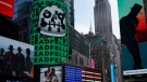An NFT, or non-fungible token, is displayed on a billboard in Time Square, New York, on Nov. 4, 2021. (AP Photo/Seth Wenig)