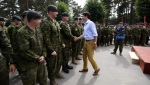 FILE - Prime Minister Justin Trudeau shakes hands with Canadian troops after delivering a speech at the Adazi Military Base in Kadaga, Latvia, on July 10, 2018. THE CANADIAN PRESS/Sean Kilpatrick