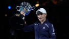 Ash Barty of Australia holds the Daphne Akhurst Memorial Cup aloft after defeating Danielle Collins of the U.S in the women's singles final at the Australian Open tennis championships in Melbourne, Australia, Saturday, Jan. 29, 2022. (AP Photo/Simon Baker)