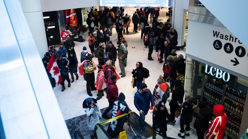People gather in the Rideau Centre mall to warm up as Ottawa is under an extreme cold warning, during a rally against COVID-19 restrictions in downtown Ottawa, on Saturday, Jan. 29, 2022. The rally began as a cross-country convoy protesting a federal vaccine mandate for truckers. (Justin Tang/THE CANADIAN PRESS)