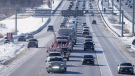 A trucker convoy driving to Parliament Hill in Ottawa to participate in a cross-country truck convoy protesting measures taken by authorities to curb the spread of COVID-19 and vaccine mandates makes it's way on the highway near Kanata, Ont. on Saturday, Jan. 29, 2022. (Frank Gunn/THE CANADIAN PRESS)