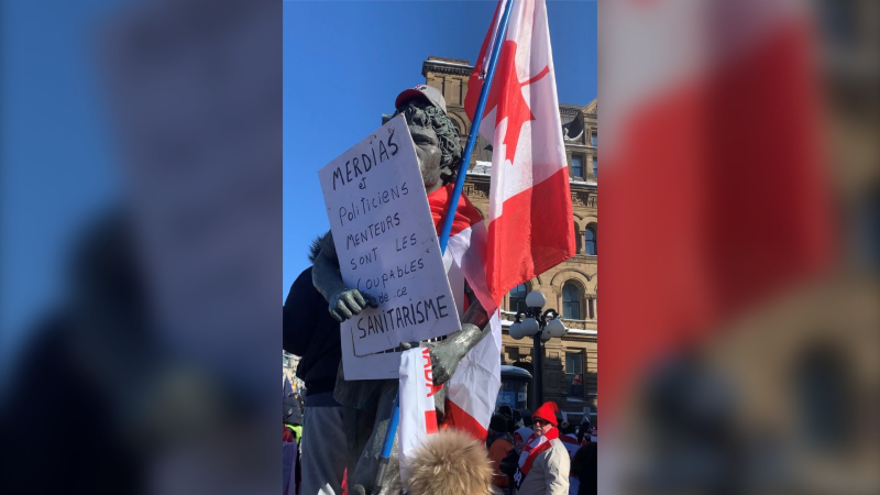 The Terry Fox statue in downtown Ottawa had a protest sign and upside down Canadian flag placed on it on Saturday, Jan. 29, 2022. (Andrew Pinsent/Newstalk 580 CFRA).