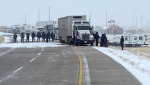  RCMP officers began removing protesters and vehicles near the Canada-U.S. border crossing at Coutts. 