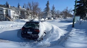 A car is seen covered in snow on Dalgliesh Drive, just off of Courtney Street in Regina on Feb. 1, 2022. (Jason Delesoy/CTV News)