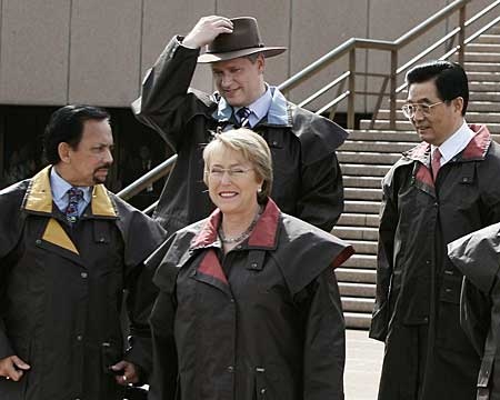 Prime Minister Stephen Harper, top left, adjusts his hat as he stands with other APEC leaders. (AP Photo/Rob Griffith)