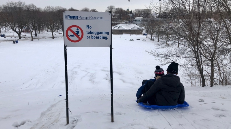 The city put up a sign reminding residents that tobogganing is banned in Christie Pits Park in Toronto (CTV News Toronto/ Hannah Alberga).