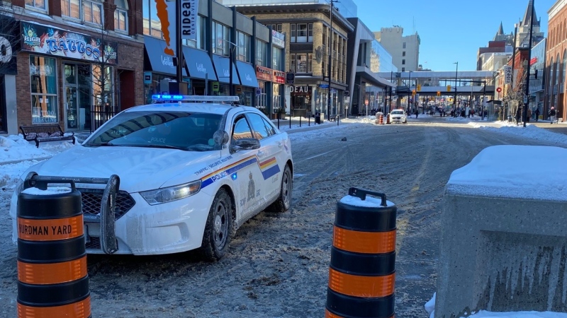 An RCMP vehicle blocks Rideau Street in downtown Ottawa, as more protesters and heavy vehicles in support of the "Freedom Convoy" occupation prepare to come to Ottawa. (Natalie Van Rooy/CTV News Ottawa)