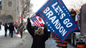 A person waves a "Let’s Go Brandon" flag, code for an expletive against U.S. President Joe Biden used by supporters of former U.S. President Donald Trump, during a rally against COVID-19 restrictions in Ottawa, on Saturday, Jan. 29, 2022. THE CANADIAN PRESS/Justin Tang