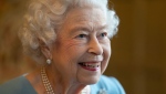 FILE - Queen Elizabeth II smiles during a reception with representatives from local community groups to celebrate the start of the Platinum Jubilee, at Sandringham House, her Norfolk residence, in Sandringham, England, Saturday, Feb. 5, 2022. (Joe Giddens/Pool Photo via AP)