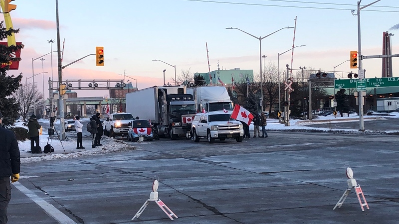Supporters of the trucker convoy on Huron Church Road near the Ambassador Bridge border crossing in Windsor, Ont., on Tuesday, Feb.8, 2022. (Sijia Liu / CTV Windsor)