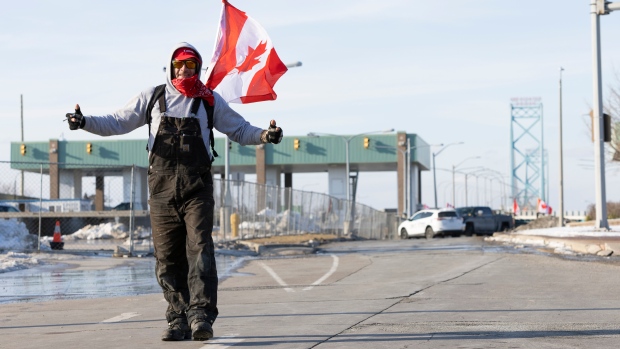 Trucker protests snarl border crossings, shut down production in car plants