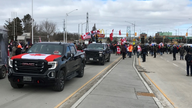 Police officers move in on demonstrators near the Ambassador Bridge in Windsor, Ont., Feb. 12, 2022. (Michelle Maluske / CTV News)