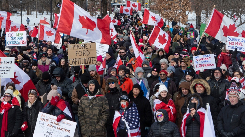 Protesters gather in Toronto to voice their opposition to COVID-19 vaccine mandates, on Saturday, February 12, 2022. THE CANADIAN PRESS/Chris Young