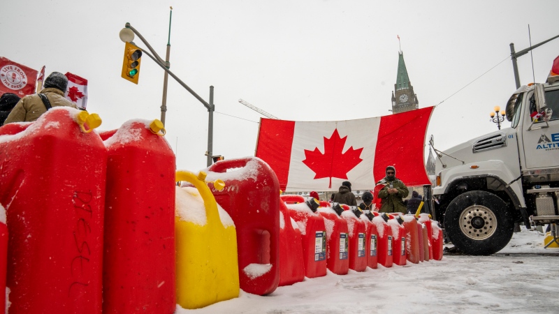 Gas cans sit in a row during a demonstration against COVID-19 restrictions on Parliament Hill, in Ottawa, Saturday, Feb. 12, 2022. THE CANADIAN PRESS/Frank Gunn