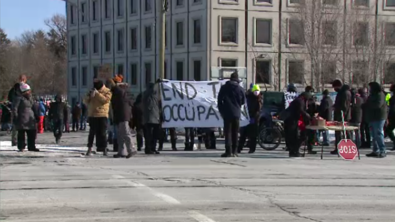 Counter-protesters block the "Blue Collar Convoy" at the intersection of Riverside Drive and Bank Street Sunday morning. (Aaron Reid/CTV News Ottawa)