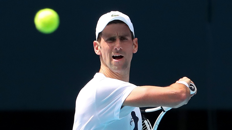 Novak Djokovic plays a forehand return during a practice session in the Rod Laver Arena ahead of the Australian Open at Melbourne Park in Melbourne, Australia, on Jan. 11, 2022. (Kelly Defina/Pool Photo via AP)