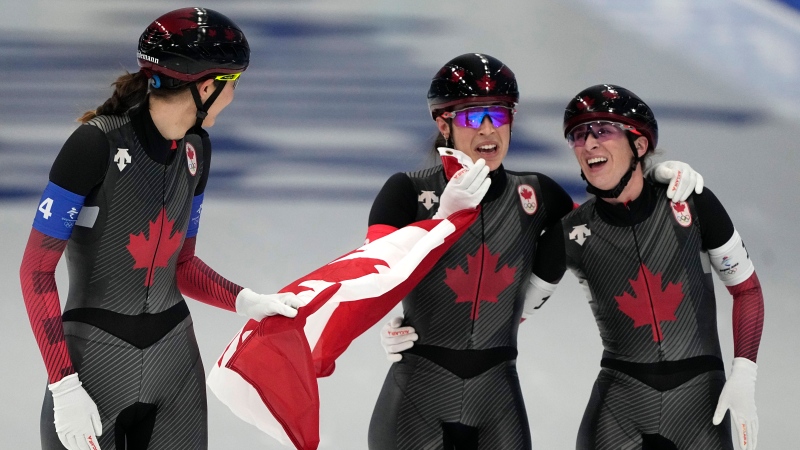 Isabelle Weidemann left, Valerie Maltais centre and Ivanie Blondin, react after wining the gold medal and setting an Olympic record in the speedskating women's team pursuit finals at the 2022 Winter Olympics in Beijing. (AP Photo/Ashley Landis)
