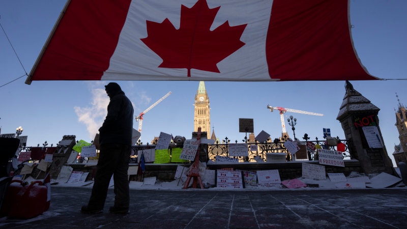 A protester walks near Parliament Hill, Tuesday, Feb. 15, 2022 in Ottawa. (Adrian Wyld/THE CANADIAN PRESS)