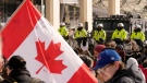 Mounted units form a line as police work to bring a protest, which started in opposition to mandatory COVID-19 vaccine mandates and grew into a broader anti-government demonstration and occupation, to an end, in Ottawa, Friday, Feb. 18, 2022. THE CANADIAN PRESS/Adrian Wyld