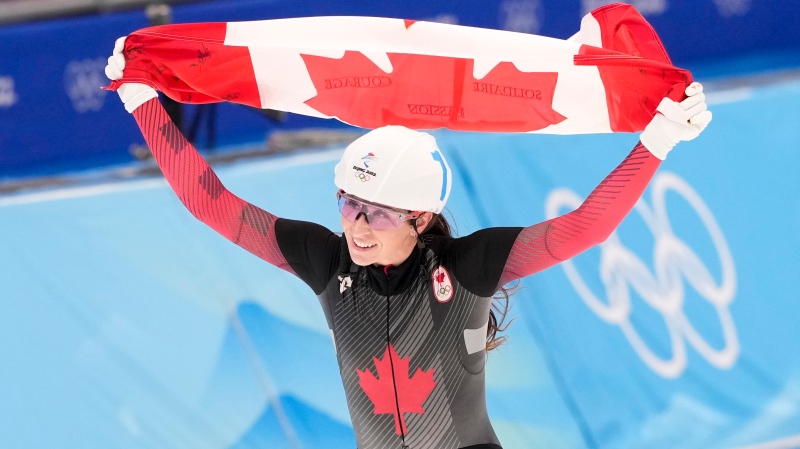 Canada's Ivanie Blondin celebrates her silver medal in the women's mass start speedskating final at the 2022 Winter Olympics in Beijing on Saturday, February 19, 2022. (THE CANADIAN PRESS / Paul Chiasson)