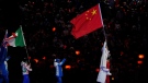 Gao Tingyu and Xu Mengtao, of China lead the march for the athletes into the stadium during the closing ceremony of the 2022 Winter Olympics, Feb. 20, 2022, in Beijing. (AP Photo/Jae C. Hong)