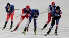 Joni Maki, of Finland, center, competes beside James Clinton Schoonmaker, right, during the men's sprint free quarterfinals cross-country skiing competition at the 2022 Winter Olympics, Tuesday, Feb. 8, 2022, in Zhangjiakou, China. (AP Photo/Alessandra Tarantino)