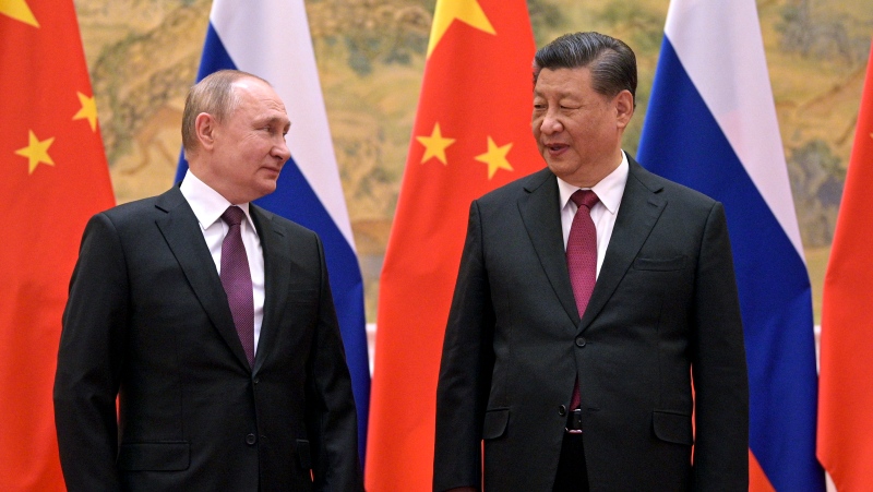Chinese President Xi Jinping, right, and Russian President Vladimir Putin talk to each other during their meeting in Beijing, China, Friday, Feb. 4, 2022. (Alexei Druzhinin, Sputnik, Kremlin Pool Photo via AP)