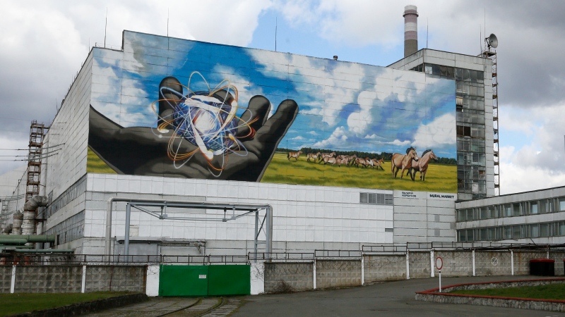 A huge mural decorates the wall at the entrance to the Chornobyl nuclear power plant, in Chornobyl, Ukraine, Tuesday, April 27, 2021. (AP Photo/Efrem Lukatsky)