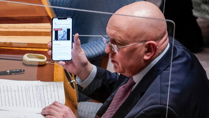 Vassily Nebenzia, Russia's United Nations Ambassador and current president of the United Nations Security Council, shows a phone image as he address the U.N. Security Council meeting on the Russian invasion of Ukraine, Friday Feb. 25, 2022 at U.N. headquarters. (AP Photo/John Minchillo) 
