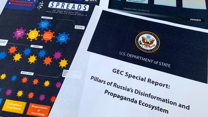 Pages from the U.S. State Department's Global Engagement Center report released on Aug. 5, 2020, are seen in this photo. (AP Photo/Jon Elswick)