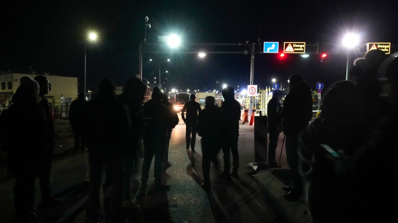 People wait for members of their family fleeing the conflict from neighbouring Ukraine at the border crossing in Medyka, southeastern Poland, on Friday, Feb. 25, 2022. (AP Photo/Czarek Sokolowski)
