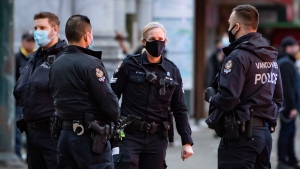 Vancouver police officers are seen in the Downtown Eastside after responding to an incident, in Vancouver, on Saturday, Jan. 9, 2021. (Darryl Dyck / THE CANADIAN PRESS)