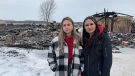 Willow Strom (left) and Tessie Chinna (right) stand in front of what remains of their flight school at the First Nations Technical Institute in Tyendinaga Mohawk Territory. The institute was destroyed in a fire Feb. 24, 2022. (Kimberley Johnson/CTV News Ottawa)