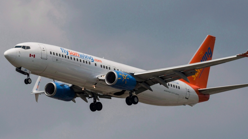A Sunwing Boeing 737-800 passenger plane prepares to land at Pearson International Airport in Toronto on Wednesday, August 2, 2017. THE CANADIAN PRESS/Christopher Katsarov 