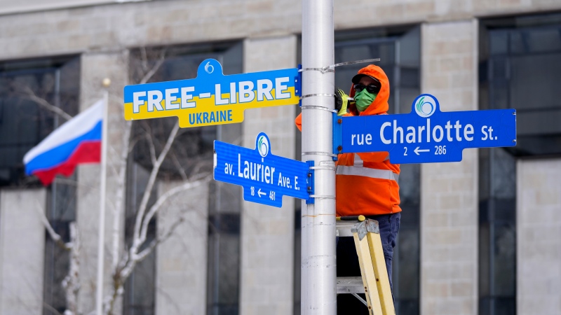 Street signs calling for a free Ukraine as a gesture of solidarity from the City of Ottawa are installed on posts along Charlotte Street in front of the Embassy of Russia in Ottawa, as Russia continues its invasion of Ukraine, on Wednesday, March 2, 2022. (Justin Tang/THE CANADIAN PRESS)