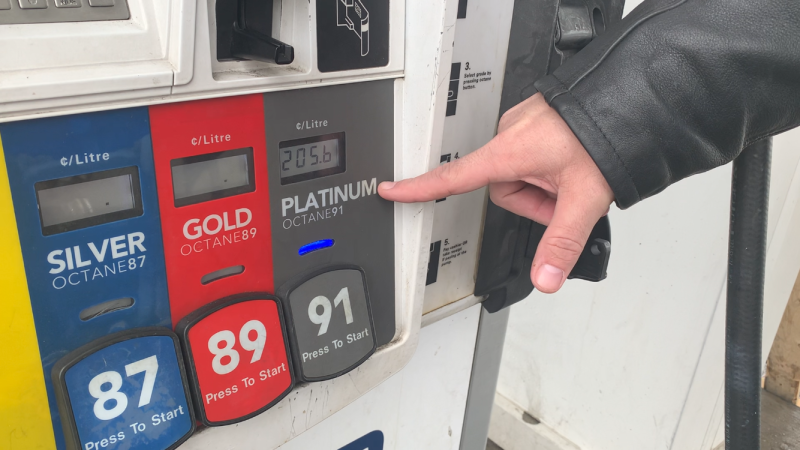 Sebastien Gauthier points to the cost of premium gasoline as he fills up on Sunday, March 6, 2022. (Jackie Perez/CTV News Ottawa)