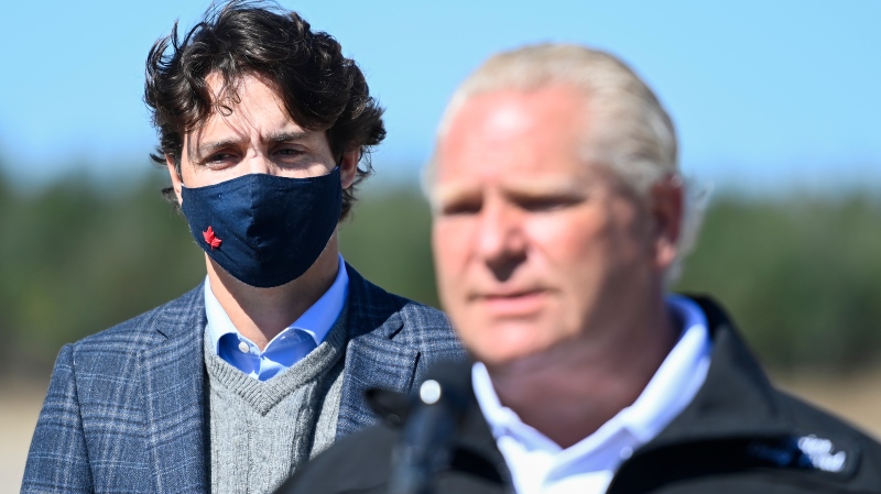 Ontario Premier Doug Ford, right, speaks to the media as Canadian Prime Minister Justin Trudeau listens after taking part in a ground breaking event at the Iamgold Cote Gold mining site in Gogama, Ont., on Friday, September 11, 2020. (THE CANADIAN PRESS/Nathan Denette)