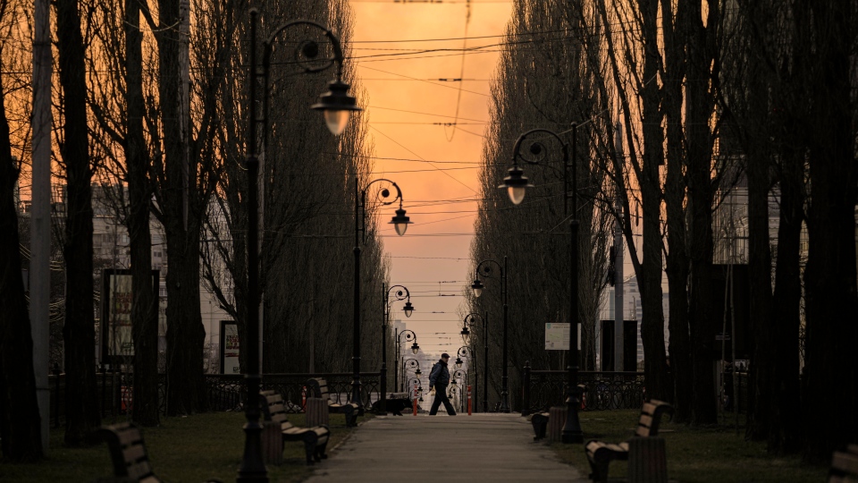 A man walks at dusk in Kyiv, Ukraine