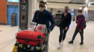 Returning travellers at the Ottawa Airport on Monday night. Under federal rules, they will need to mask up for 14 days despite Ontario lifting its mask mandate. (Jackie Perez/CTV News Ottawa)