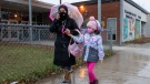 A parent and student walk away from Thorncliffe Park Public School in Toronto on Friday December 4, 2020. Toronto Public Health closed the school due to a COVID19 outbreak. THE CANADIAN PRESS/Frank Gunn