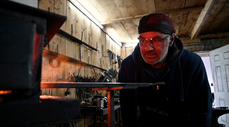 Retired Ottawa firefighter Mark Tedeschini now works as a Blacksmith at his studio 1215 Metalworks in Kemptville.  He watches a piece of steel heat up in his propane forge. (Joel Haslam/CTV News Ottawa)